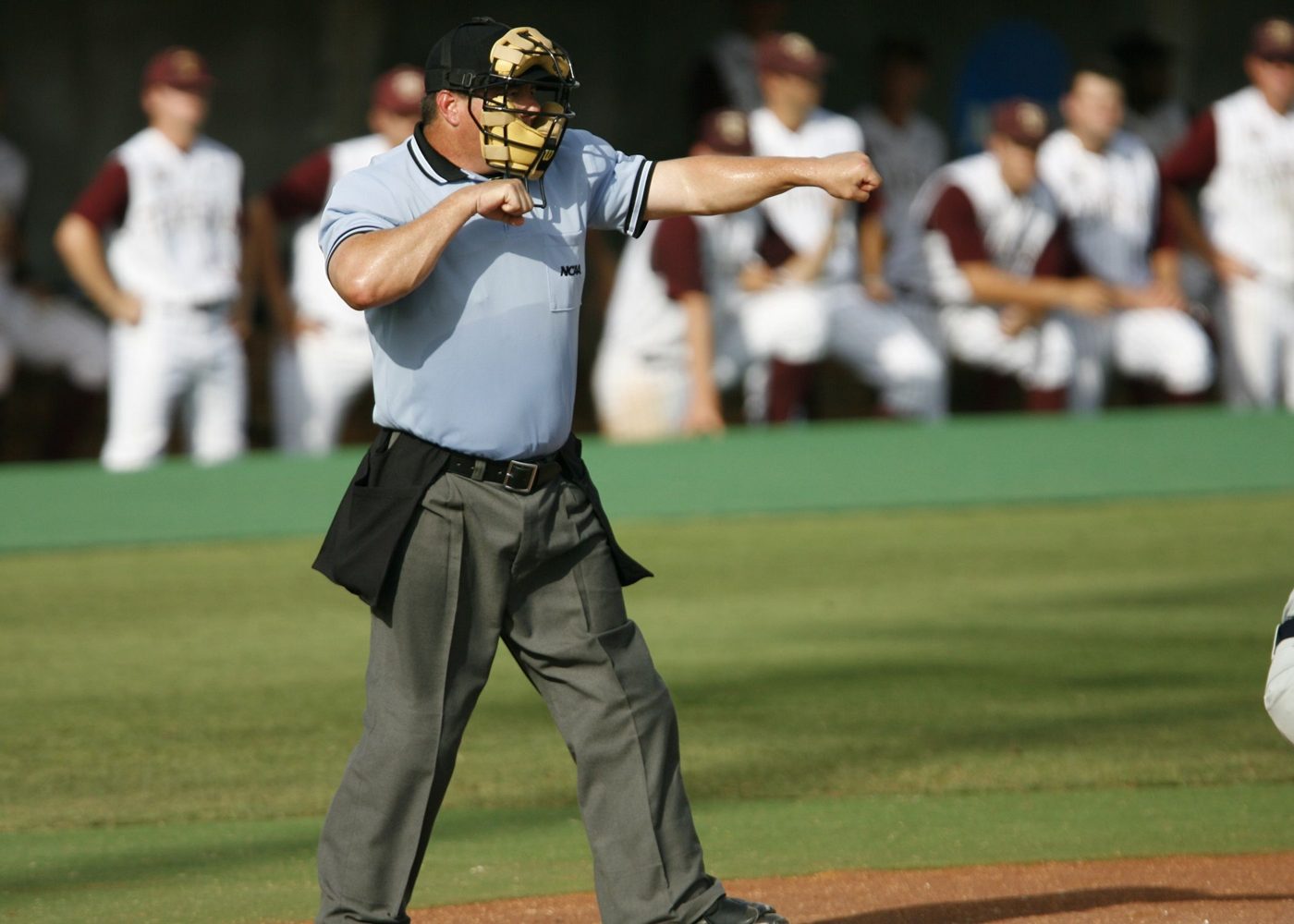 A baseball umpire signalling a call